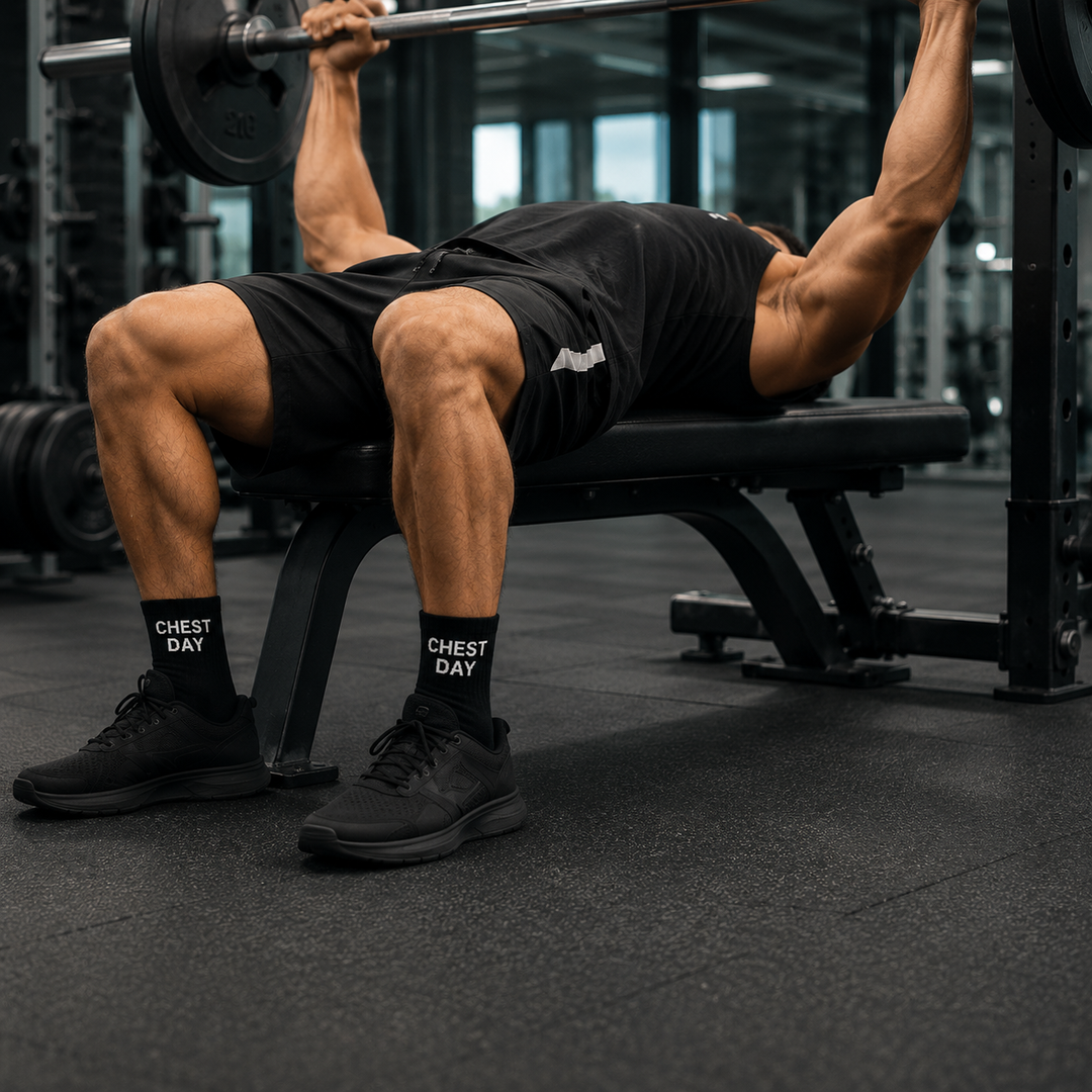 Person performing a bench press with weights in a gym setting